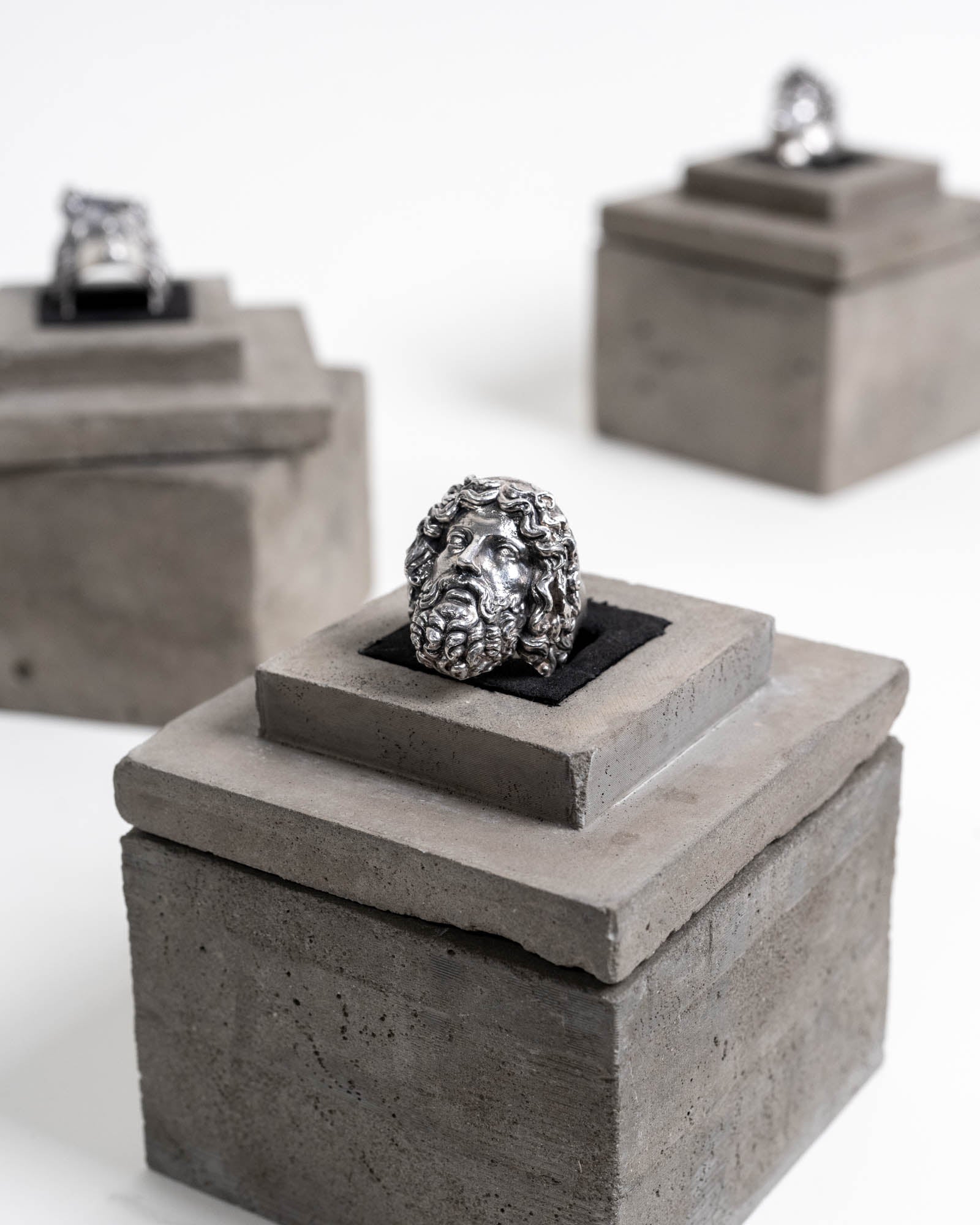 Zeus Ring Sterling Silver on top of Concrete Package